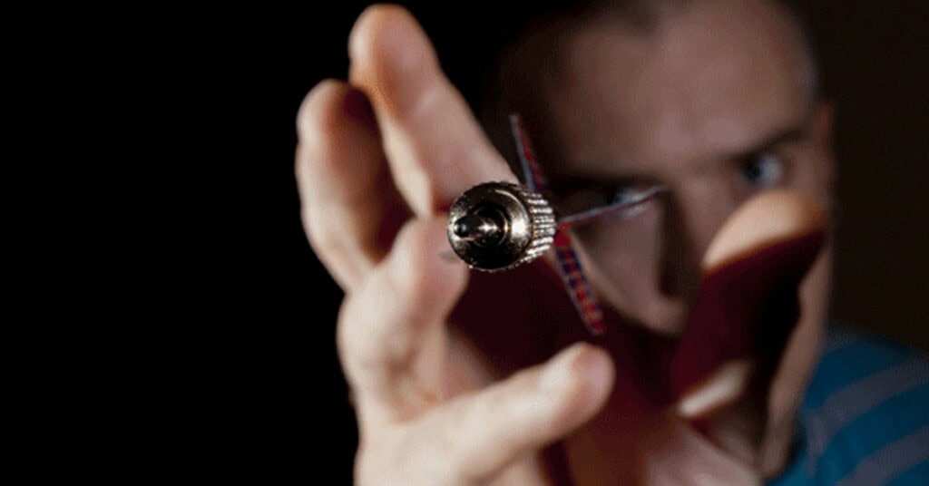 Security professional holding a surveillance tool, emphasizing cybersecurity and threat prevention services offered by Perimeter.