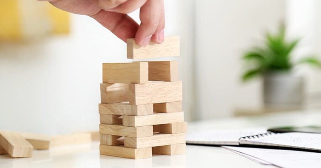 Stacked wooden blocks representing strategic planning and security concepts for perimeter management and cybersecurity.