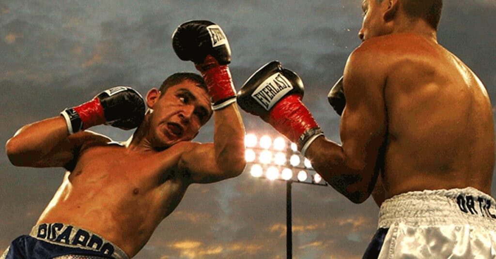Vibrant image of two boxers engaged in an intense match during a professional boxing event at twilight, showcasing athleticism, focus, and competitive spirit under stadium lights.