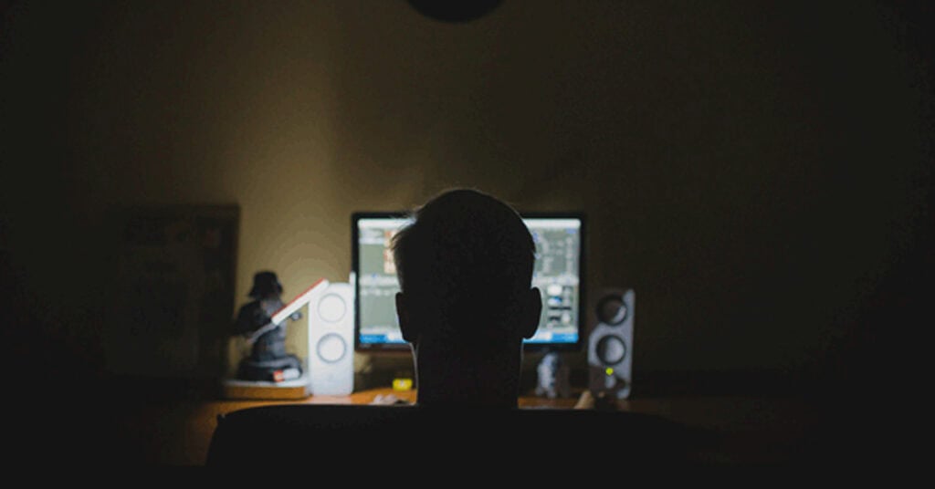 Gaming computer setup with dual monitors and speakers in a dark room, focus on digital creativity and electronic entertainment SEO-friendly, high-quality image of an advanced gaming or multimedia workstation for tech and gaming websites.