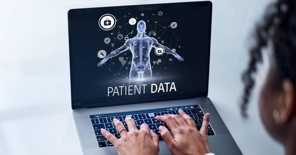 Patient data management digital interface displaying healthcare analytics on a laptop screen.