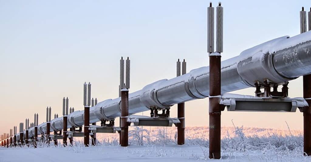Large industrial pipeline with snow-covered surroundings, emphasizing infrastructure and energy distribution.