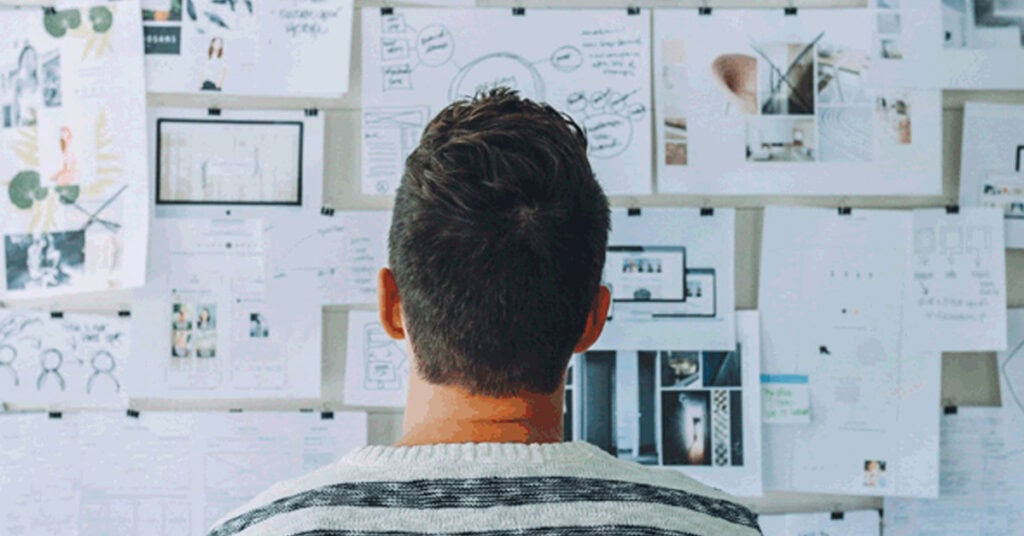 Perimeter cybersecurity analysis planning team working on whiteboard with diagrams and notes.